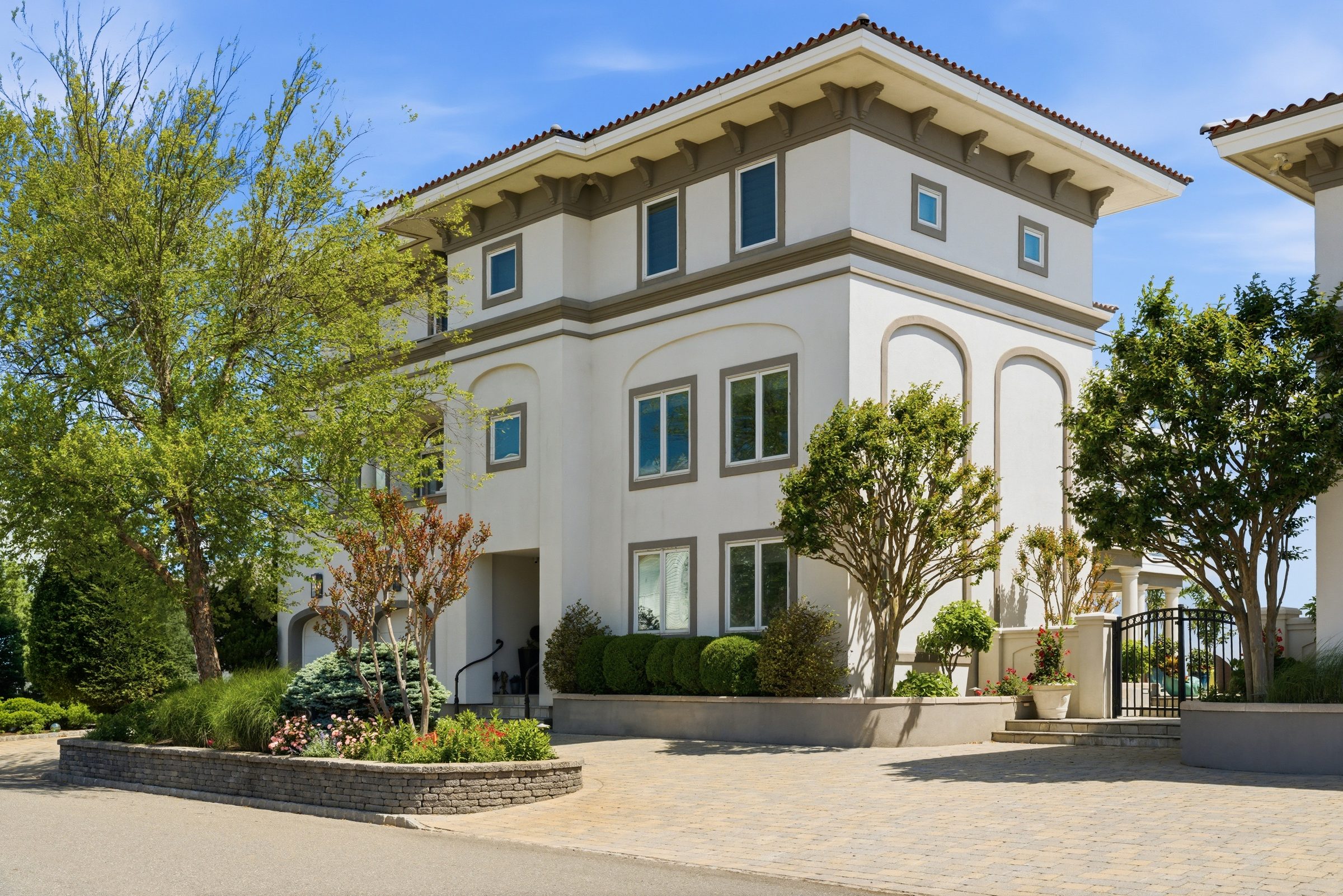 main residence facade with arched windows and Colonial-style architecture