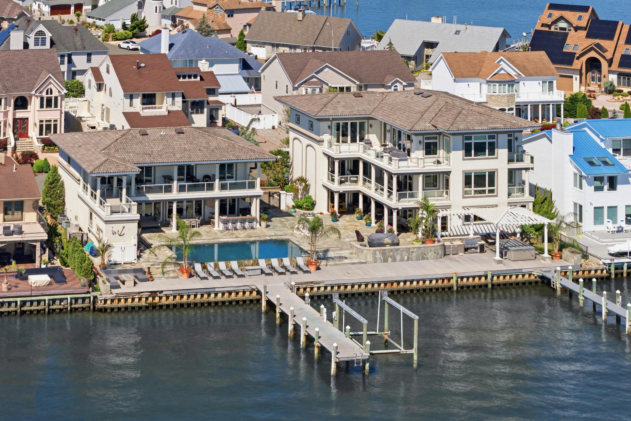 aerial view of the pool, private dock and boat lift
