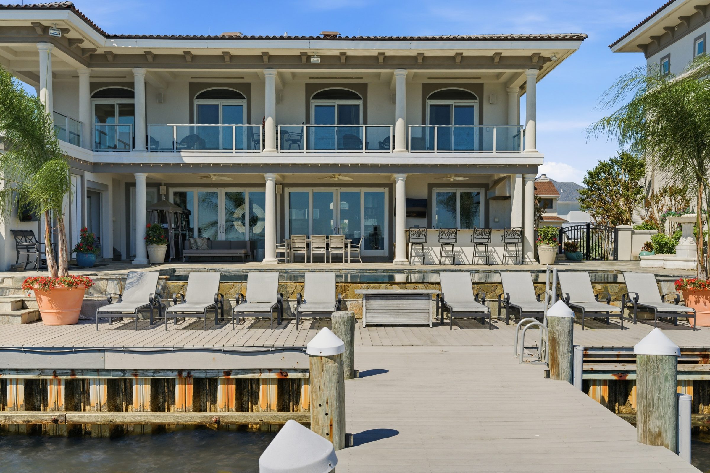 rear elevation of the main residence with columned porches and boat lift