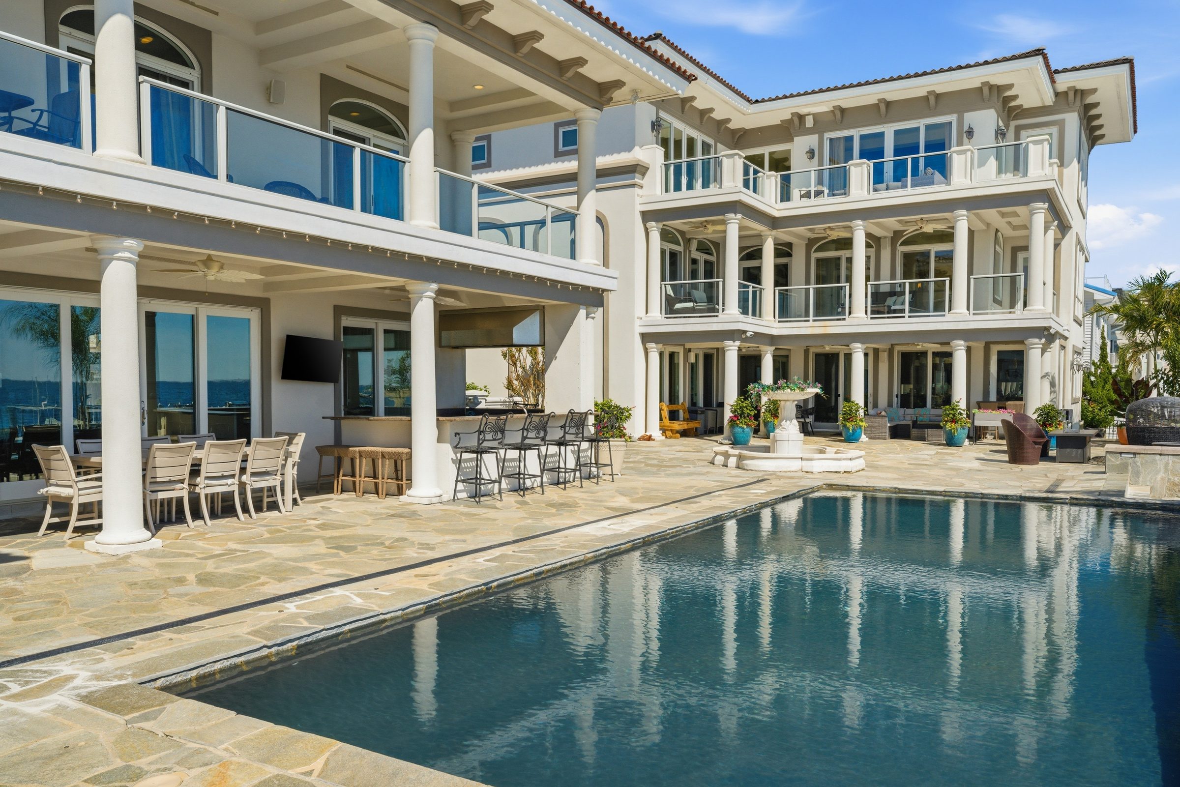 rear patio and outdoor living space overlooking the water