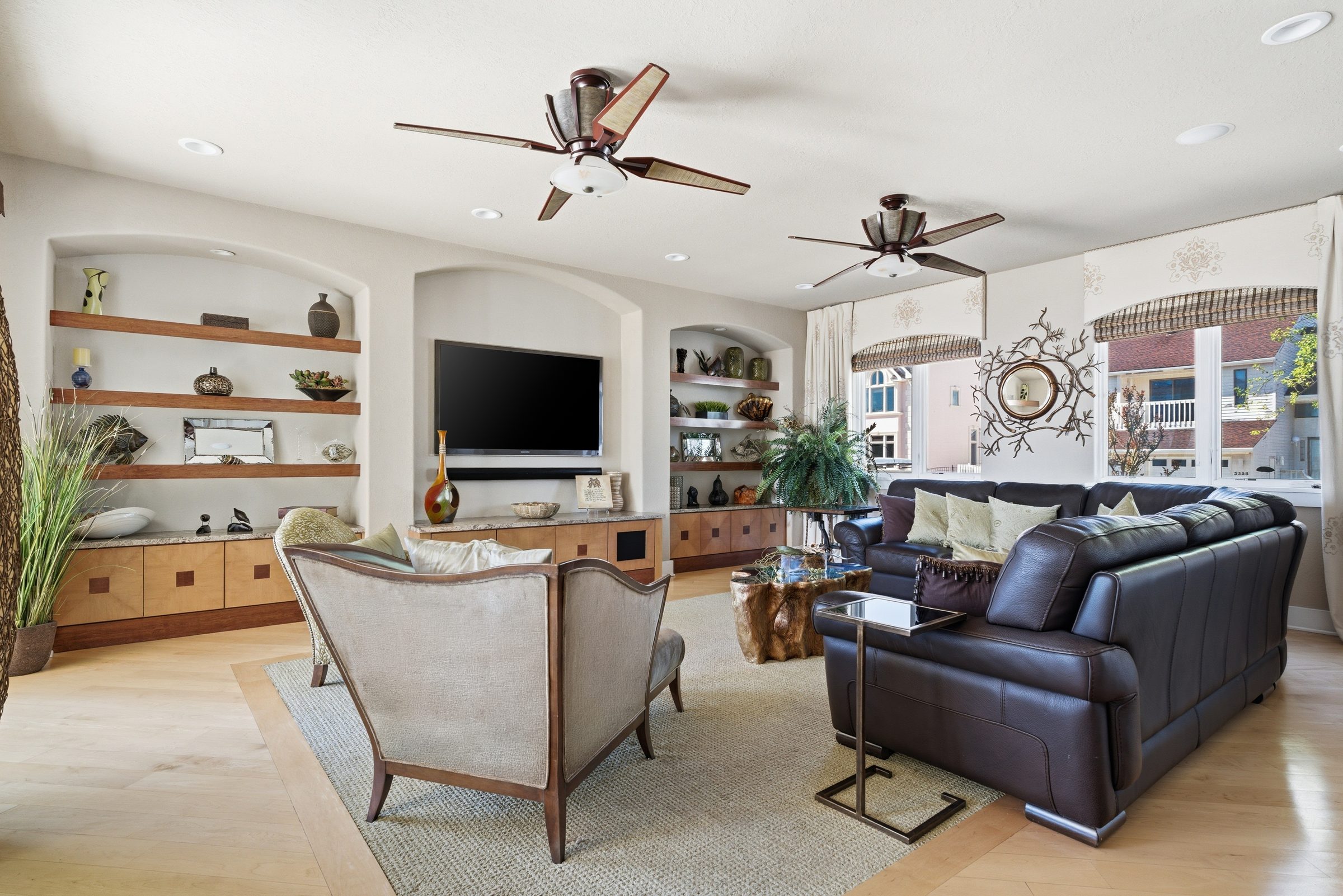 family room with custom built-in shelving and leather seating