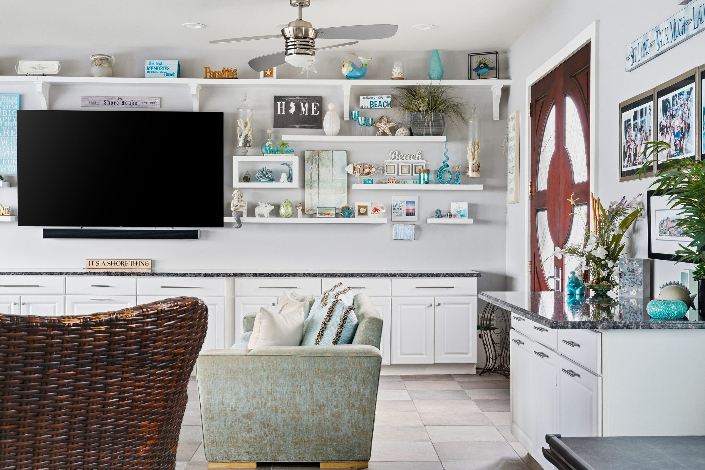 guest house den with coastal decor and wicker seating
