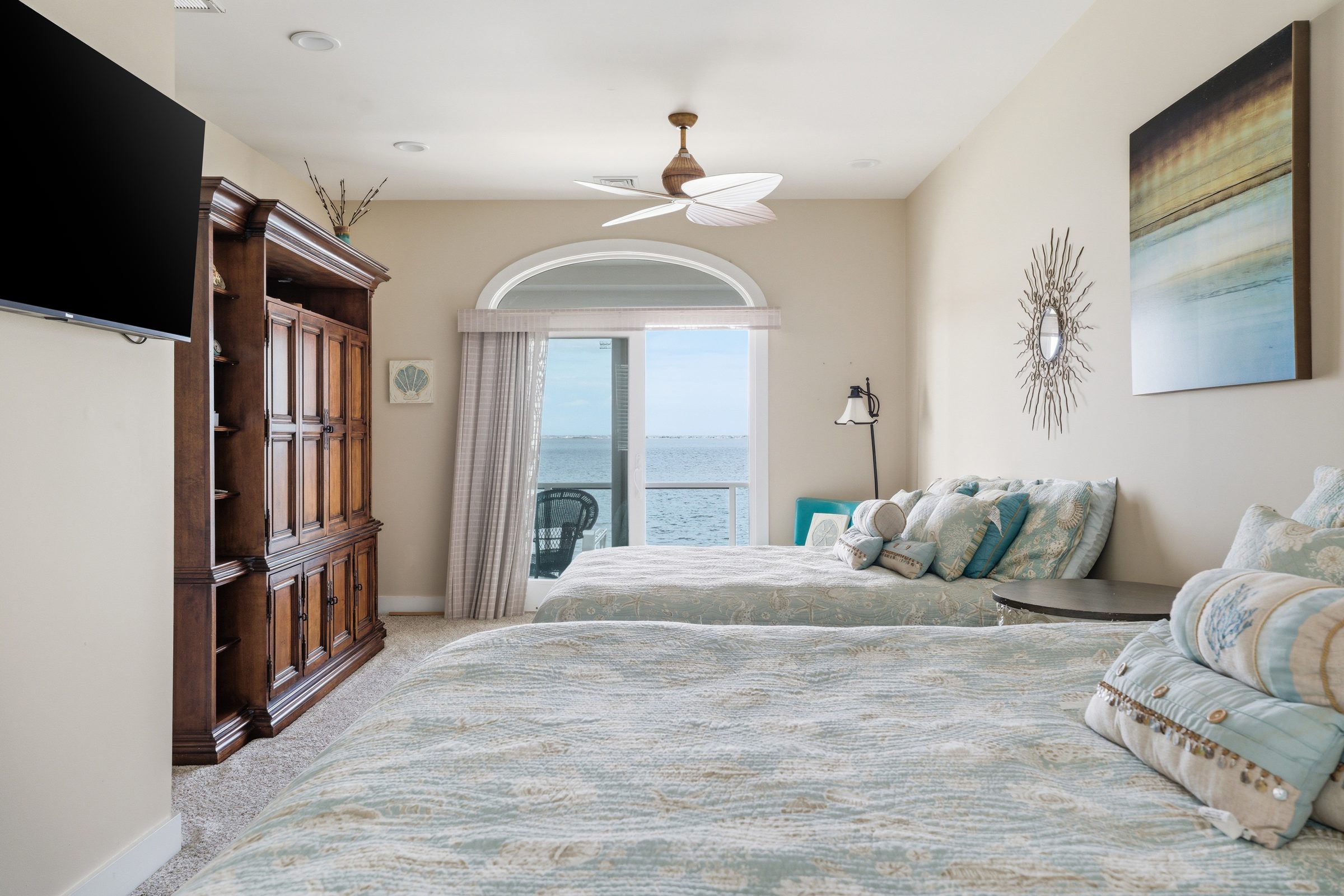guest house bedroom with coastal decor and water views
