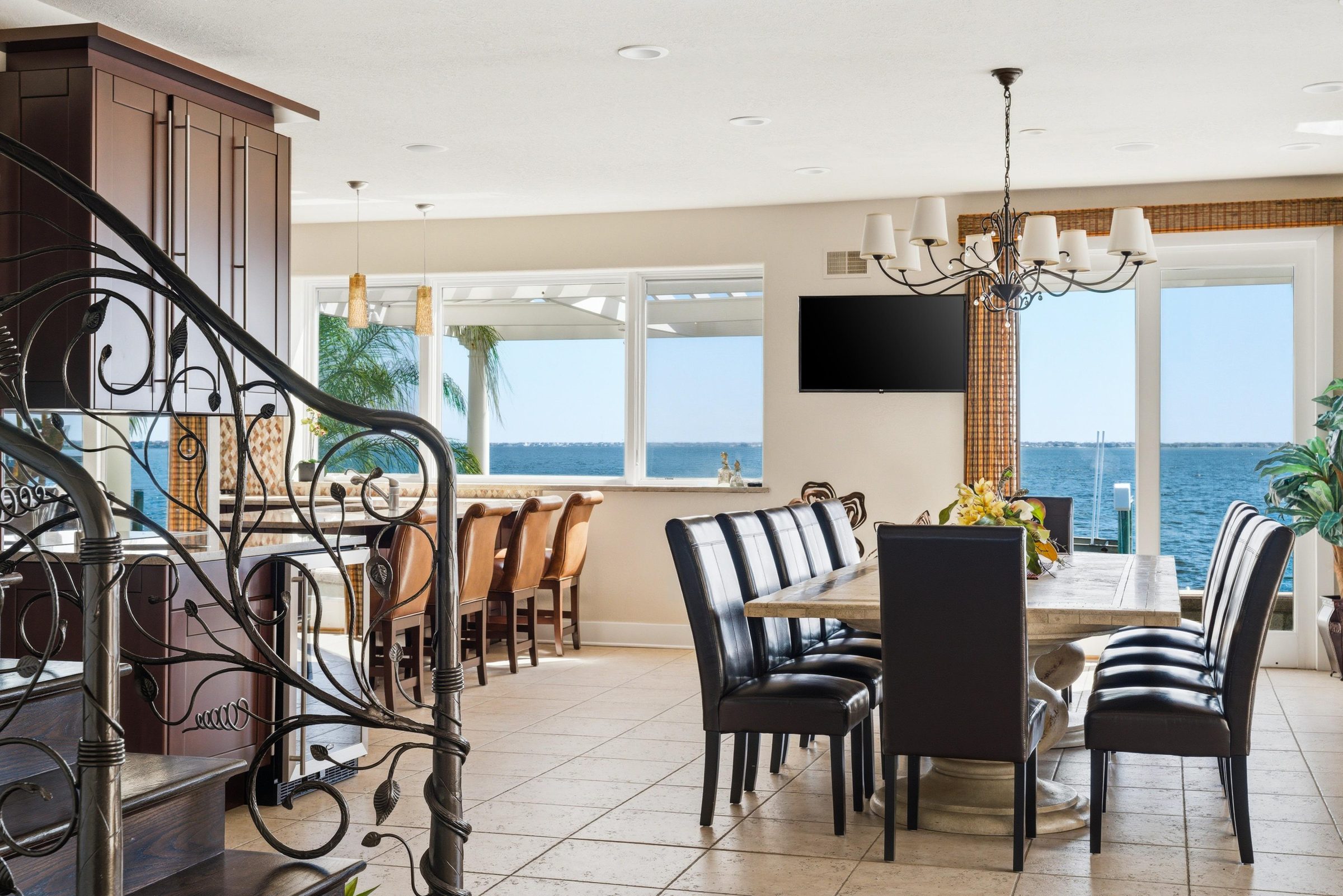 open dining and kitchen counter area with water views